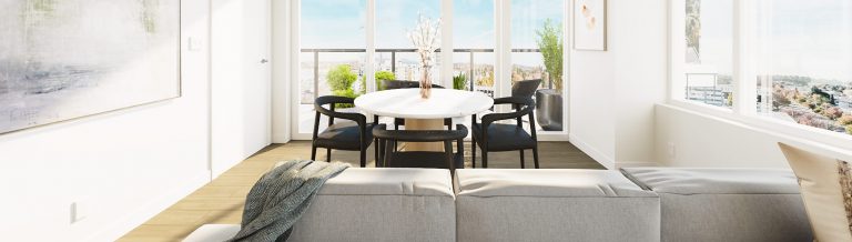 An interior shot of a NEST residence, featuring the back of a couch and, behind it, a round table and four chairs.