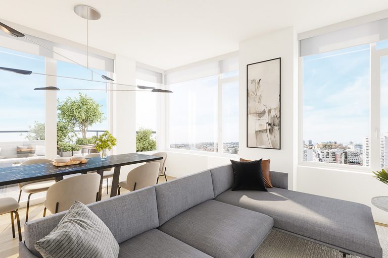A couch, table, and chairs in a light-filled residence.